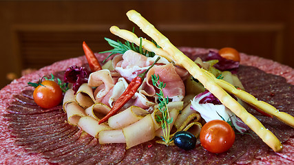 Image showing Assorted meats and sausages, olives and spices, close-up.