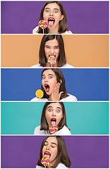 Image showing young woman with the colorful lollipop at studio