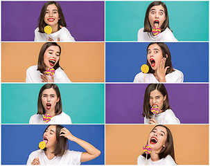 Image showing young woman with the colorful lollipop at studio