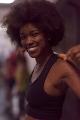 Image showing black woman lifting empty bar