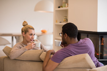 Image showing Young multiethnic couple  in front of fireplace