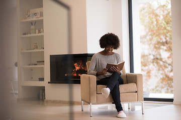 Image showing black woman at home reading book