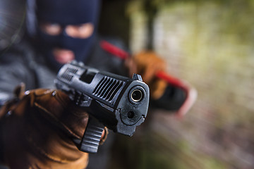 Image showing criminal poiting a gun