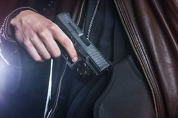 Image showing pulling a gun out of a holster by a law enforcer