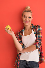 Image showing woman over color background plays with apple