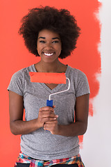 Image showing black woman painting wall