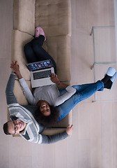 Image showing happy multiethnic couple relaxes in the living room