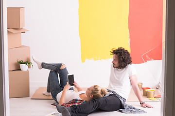 Image showing Happy young couple relaxing after painting