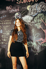Image showing young cute teenage girl in classroom at blackboard happy smiling, education people concept