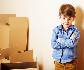 Image showing little cute boy in empty room, remoove to new house. home alone,