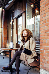 Image showing young pretty african american women drinking coffee outside in c