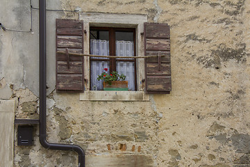 Image showing Brown wooden window shutters on the old stone house