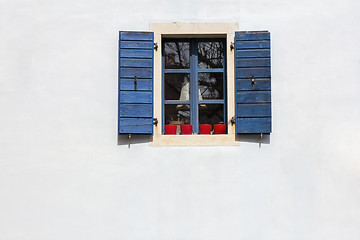 Image showing Blue window shutters on the white facade