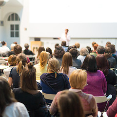 Image showing Woman giving presentation in lecture hall at university.