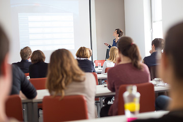 Image showing Woman giving presentation in lecture hall at university.