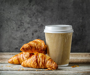 Image showing cup of coffee and freshly baked croissants