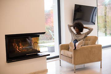 Image showing black woman in front of fireplace