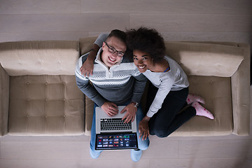 Image showing happy multiethnic couple relaxes in the living room