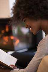 Image showing black woman at home reading book