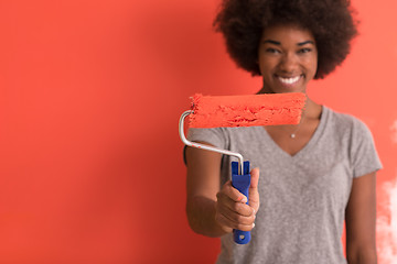 Image showing black woman painting wall