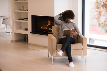 Image showing black woman at home reading book