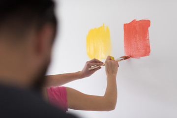 Image showing couple painting interior wall