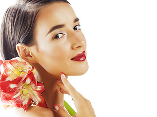 Image showing young pretty brunette woman with red flower amaryllis close up i