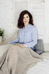 Image showing young pretty brunette woman in her bedroom sitting at window, happy smiling lifestyle people concept 