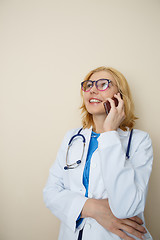 Image showing Young doctor talking on phone