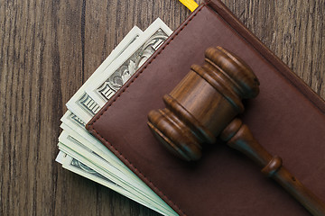 Image showing Wooden table with hammer, dollars