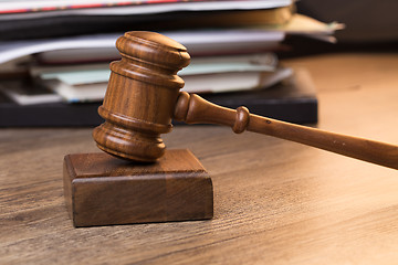 Image showing Documents, hammer on wooden table