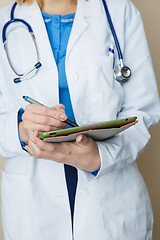 Image showing Doctor with phonendoscope making notes