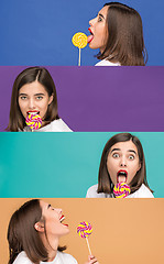 Image showing young woman with the colorful lollipop at studio