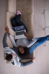 Image showing happy multiethnic couple relaxes in the living room