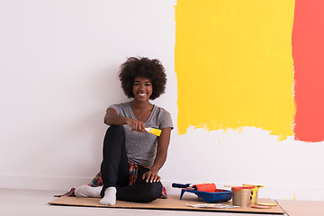 Image showing back female painter sitting on floor