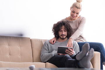 Image showing couple relaxing at  home with tablet computers