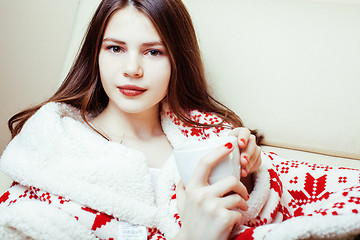 Image showing young pretty brunette girl in Christmas ornament blanket getting warm on cold winter, freshness beauty concept, lifestyle people