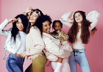 Image showing three different nation girls with diversuty in skin, hair. Asian, scandinavian, african american cheerful emotional posing on pink background, woman day celebration, lifestyle people concept 