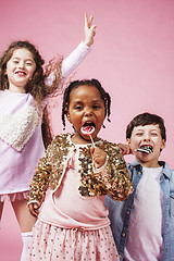 Image showing lifestyle people concept: diverse nation children playing together, caucasian boy with african little girl holding candy happy smiling 