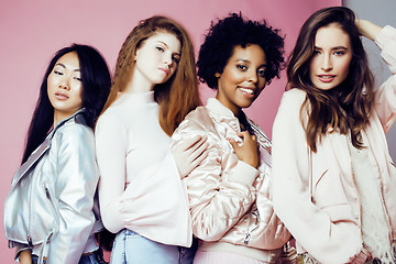 Image showing three different nation girls with diversuty in skin, hair. Asian, scandinavian, african american cheerful emotional posing on pink background, woman day celebration, lifestyle people concept 