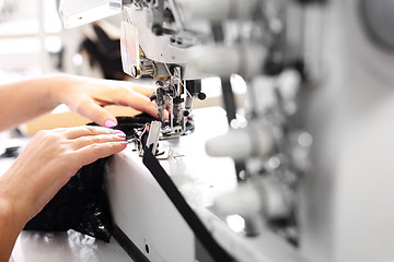 Image showing Sewing on a machine. 