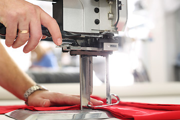 Image showing Cutting room, cutting cloth tailoring knife. 