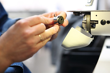 Image showing Sewing. Sewing machine  Seamstress sewing on the sewing machine in the manufacturing plant 