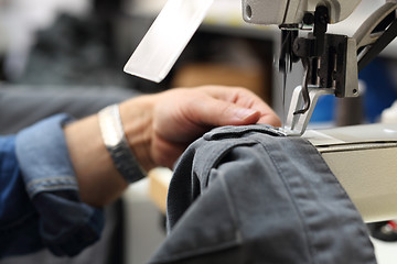 Image showing Sewing. Factory, sewing room. Production of apparel. Occupation needlewoman.