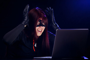 Image showing Surprised night hacker by laptop