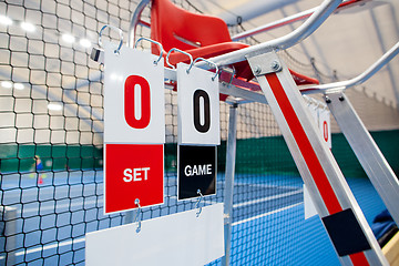 Image showing Umpire chair with scoreboard on a tennis court before the game.