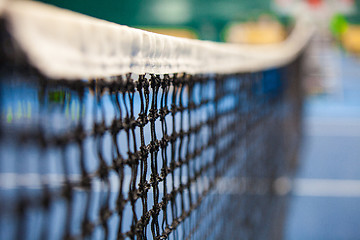 Image showing Close up view of tennis court through the net