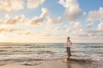 Image showing Free Happy Woman Enjoying Sunset on Sandy Beach