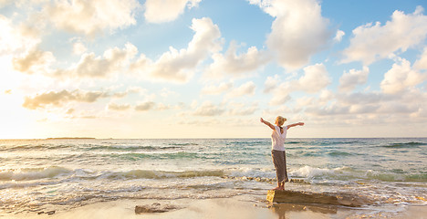 Image showing Free Happy Woman Enjoying Sunset on Sandy Beach