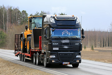 Image showing Black DAF XF Semi Truck Hauls Wheel Loader